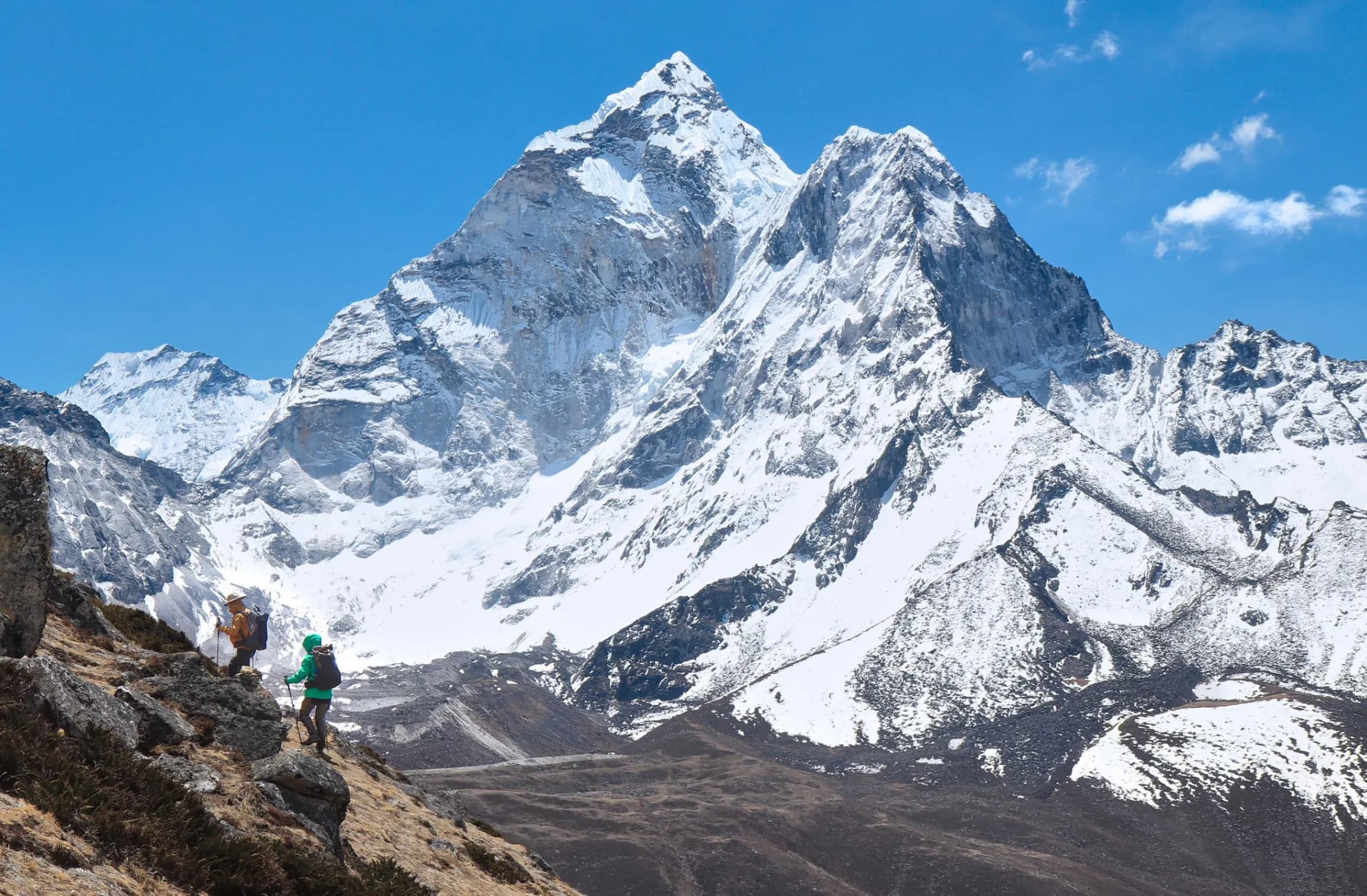 Trekkers on the trail to Everest Base Camp with snow-covered Himalayan peaks in the background